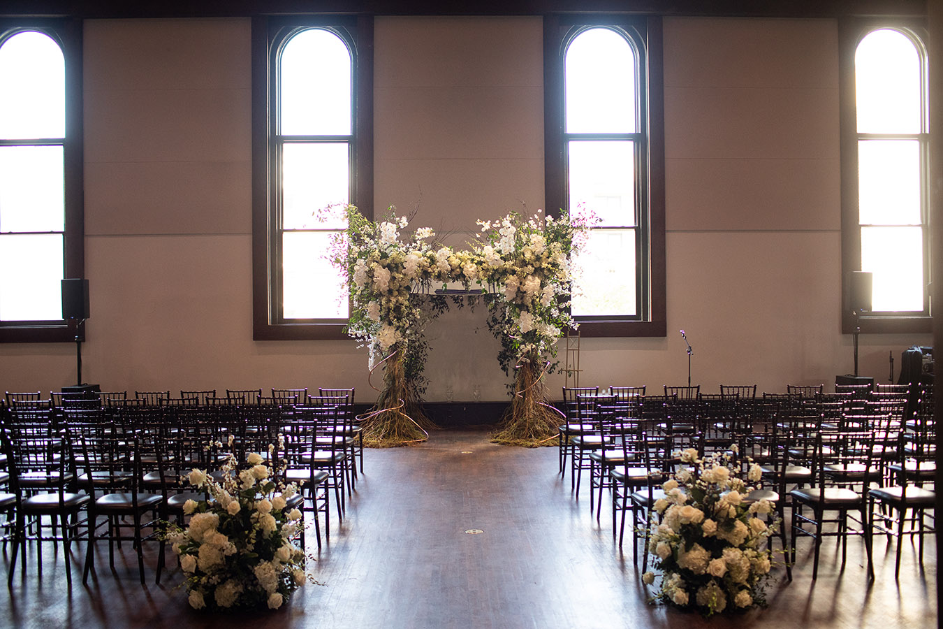 Wedding ceremony setup with Jewish chuppah adorned with flowers
