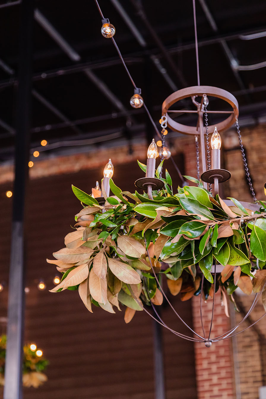 Small iron chandelier decorated with magnolia leaves