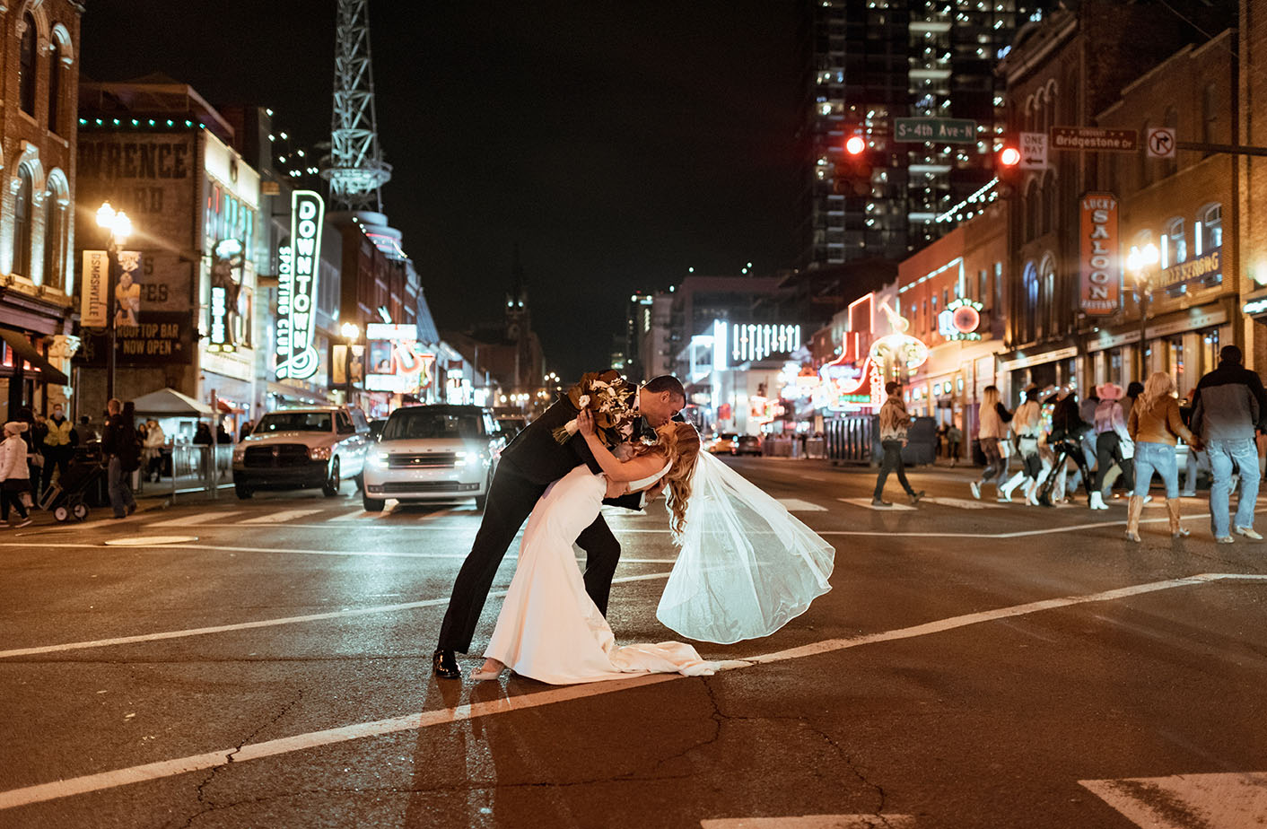 Bride and groom kiss in the middle of Broadway in downtown Nashville