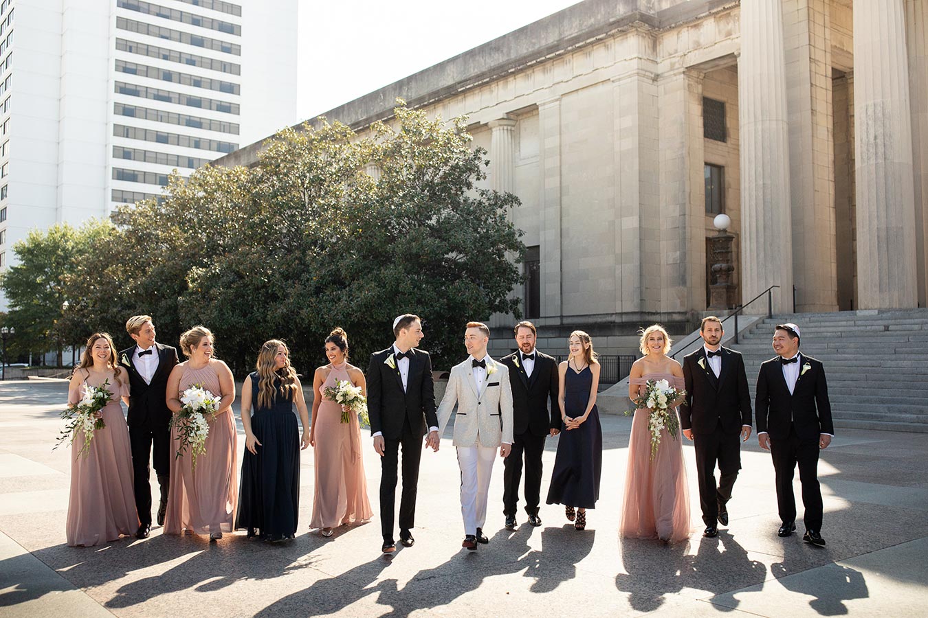 Two Grooms in Grey and Black Tuxedos | Groomsmen in Classic Tuxes and Bridesmaids in Blush Halter-Top Dresses | Wedding Party Style Inspiration | Gay Wedding in Downtown Nashville