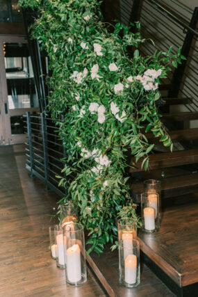 The Bell Tower staircase decorated with greenery and white flowers